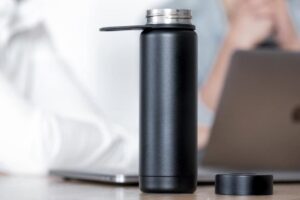 black smart water bottle on office desk