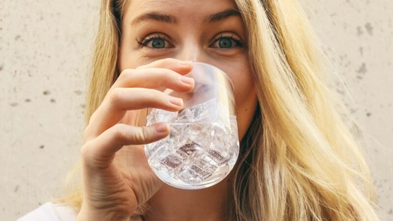 young girl is drinking water