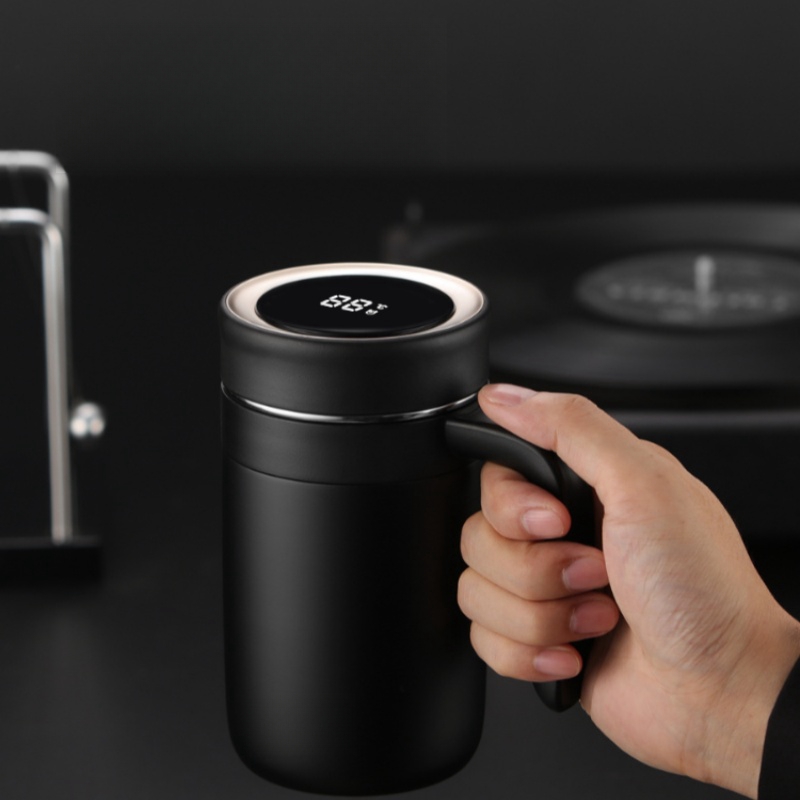 black insulated mug with a handle.