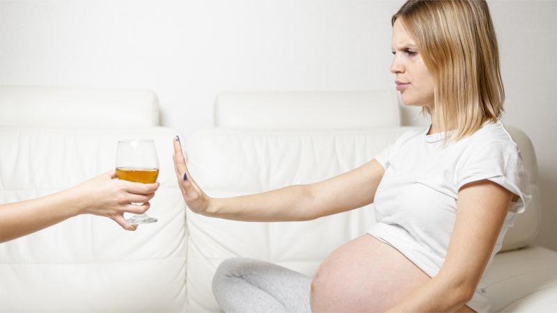 pregnant woman refusing to drink alcohol
