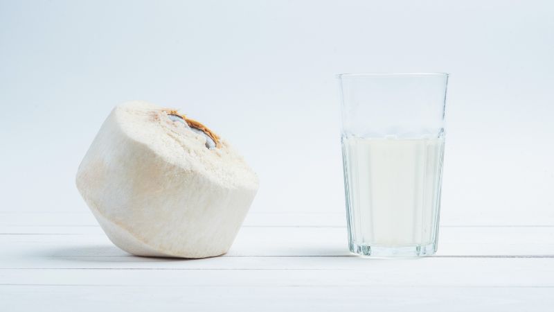a glass of coconut water and nut