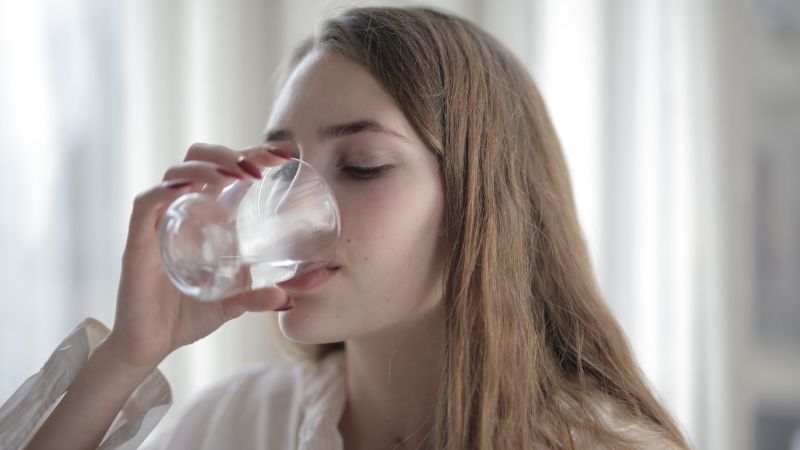 younger woman drinking water