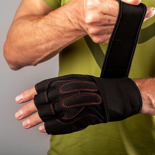 putting on training workout gloves on hands for wrist protection